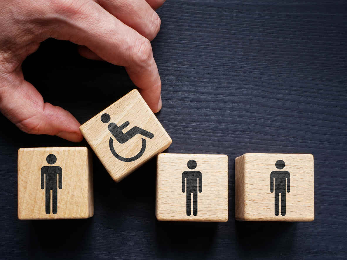 Wooden blocks illustrating inclusion of individuals with disabilities in the workforce, relevant to employee disability rights in California for both part-time and full-time staff.
